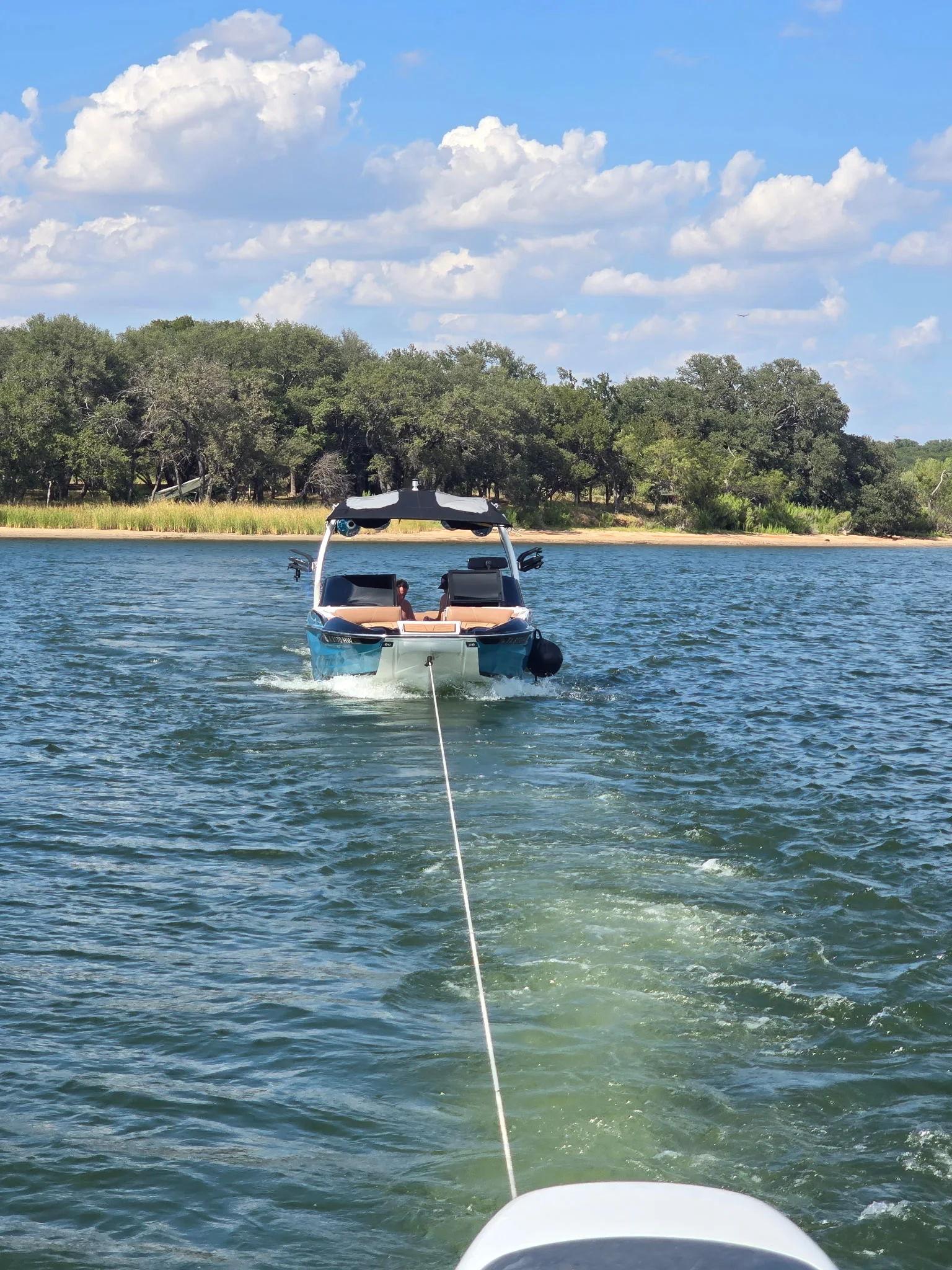 Towing a boat back across Possum Kingdom Lake, tow line stretched out behind.