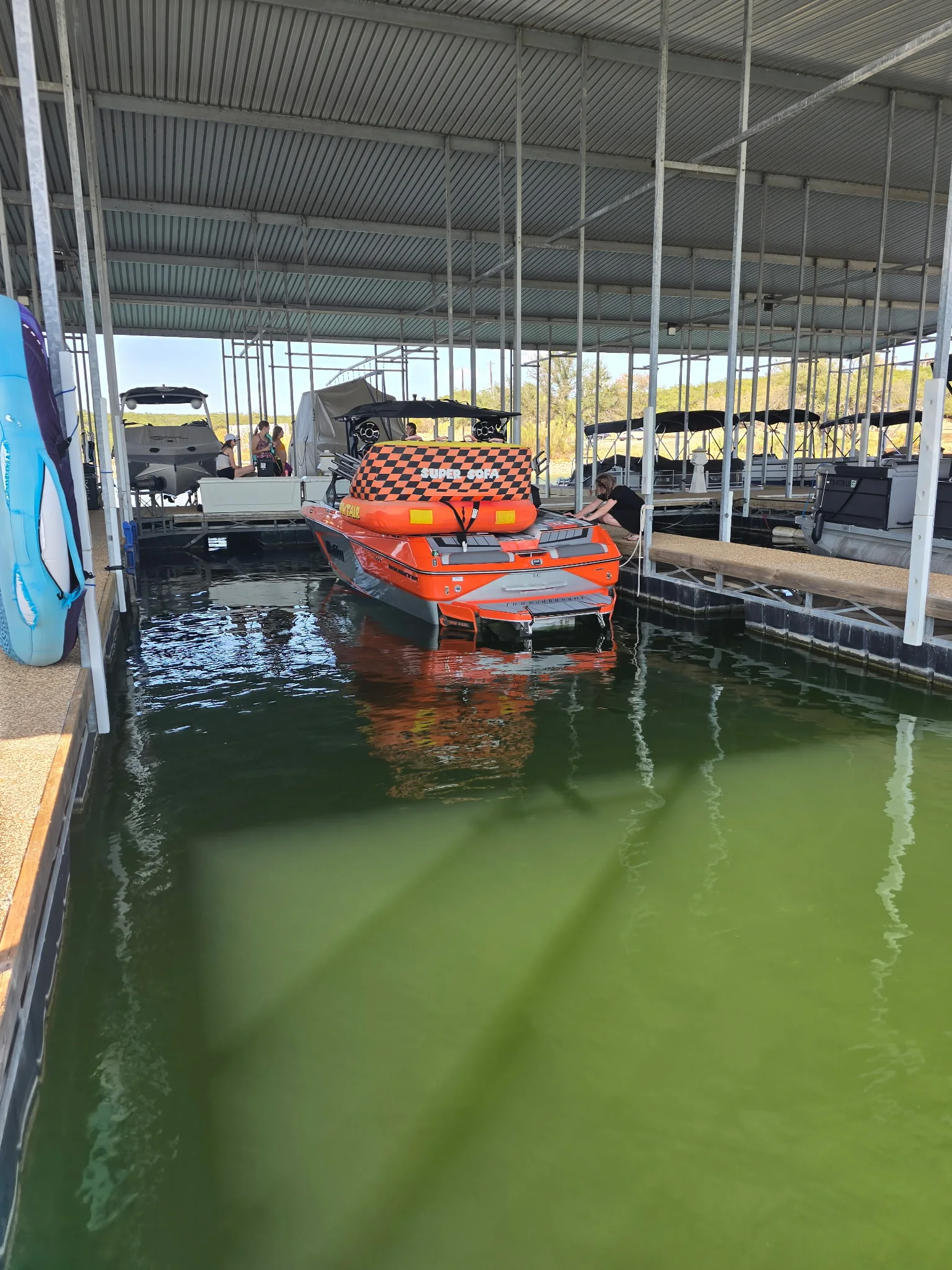 A boat tucked into a covered slip at a Possum Kingdom Lake marina.